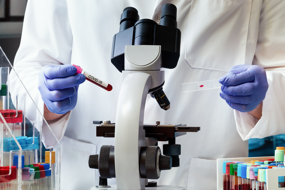 a scientist holding a blood sample